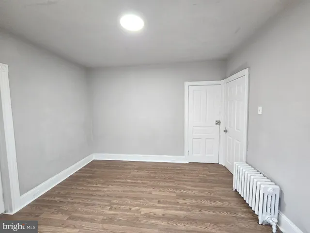 a view of a room with wooden floor