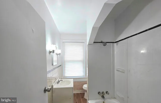 a bathroom with a bathtub and shower