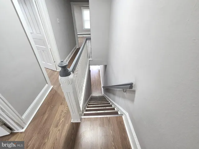 a view of entryway and hall with wooden floor