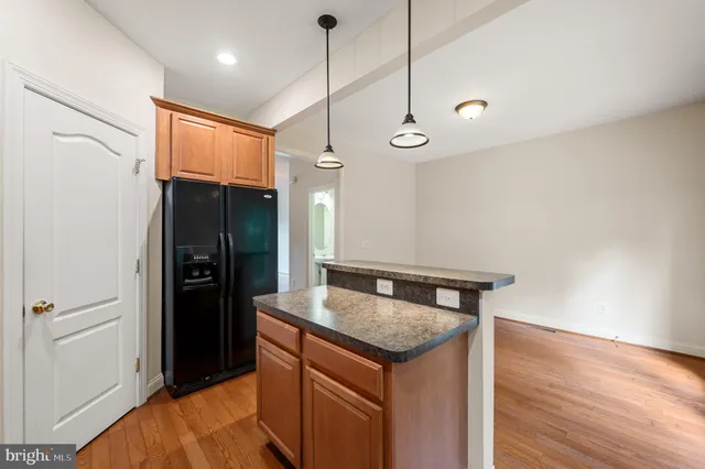 a kitchen with stainless steel appliances granite countertop a refrigerator a sink and a refrigerator