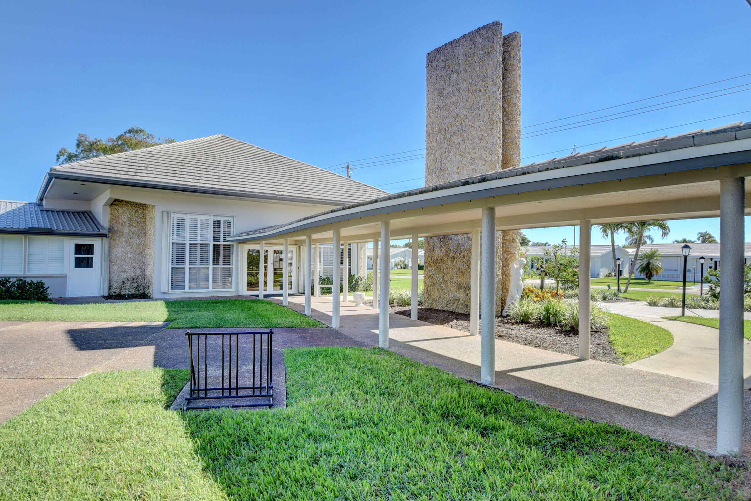 716 Southwest 18th Street Boynton Beach, FL 33426 - Photo 17 of 65 a view of a house with a yard and porch