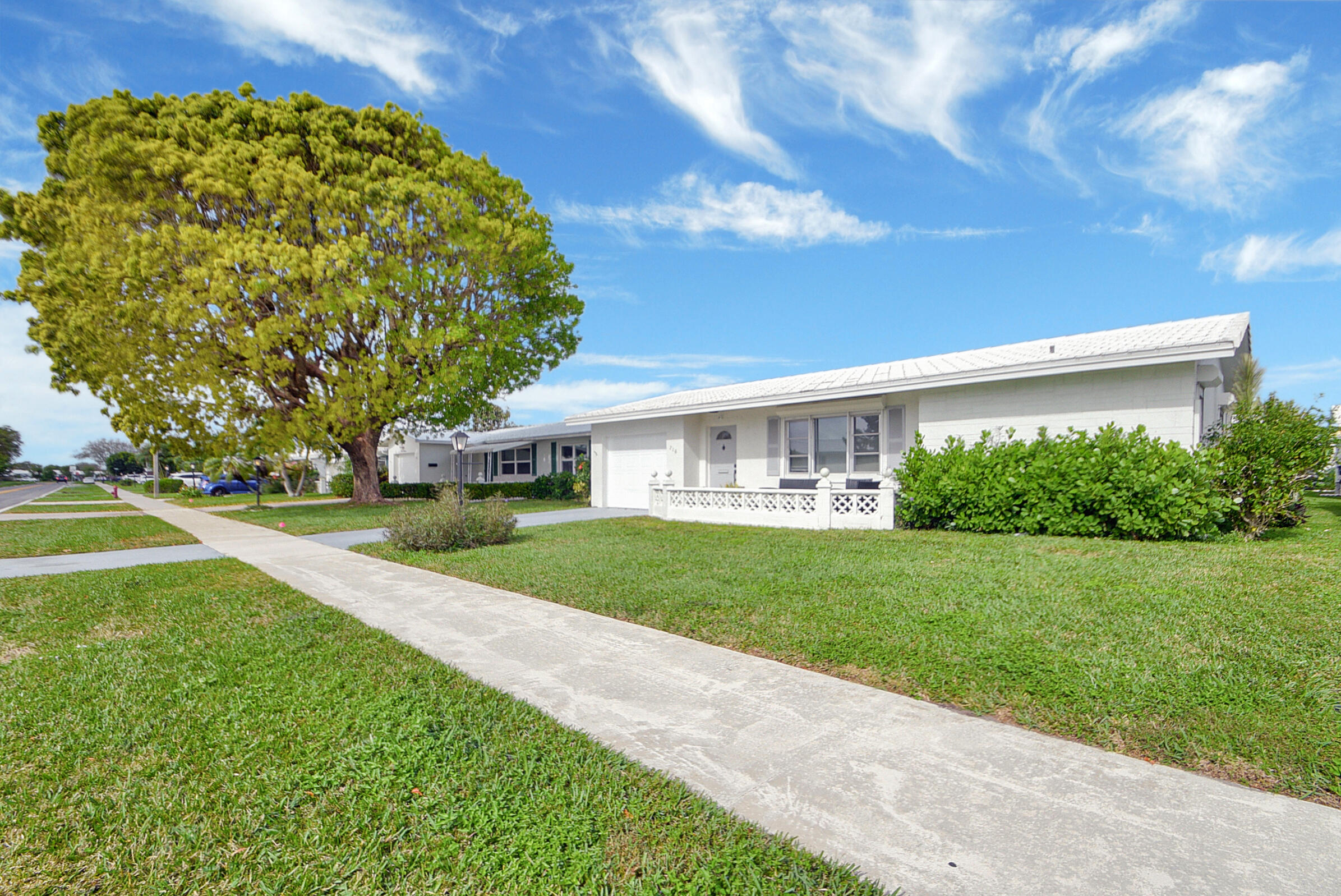 716 Southwest 18th Street Boynton Beach, FL 33426 - Photo 31 of 65 a view of a house with a big yard plants and large trees