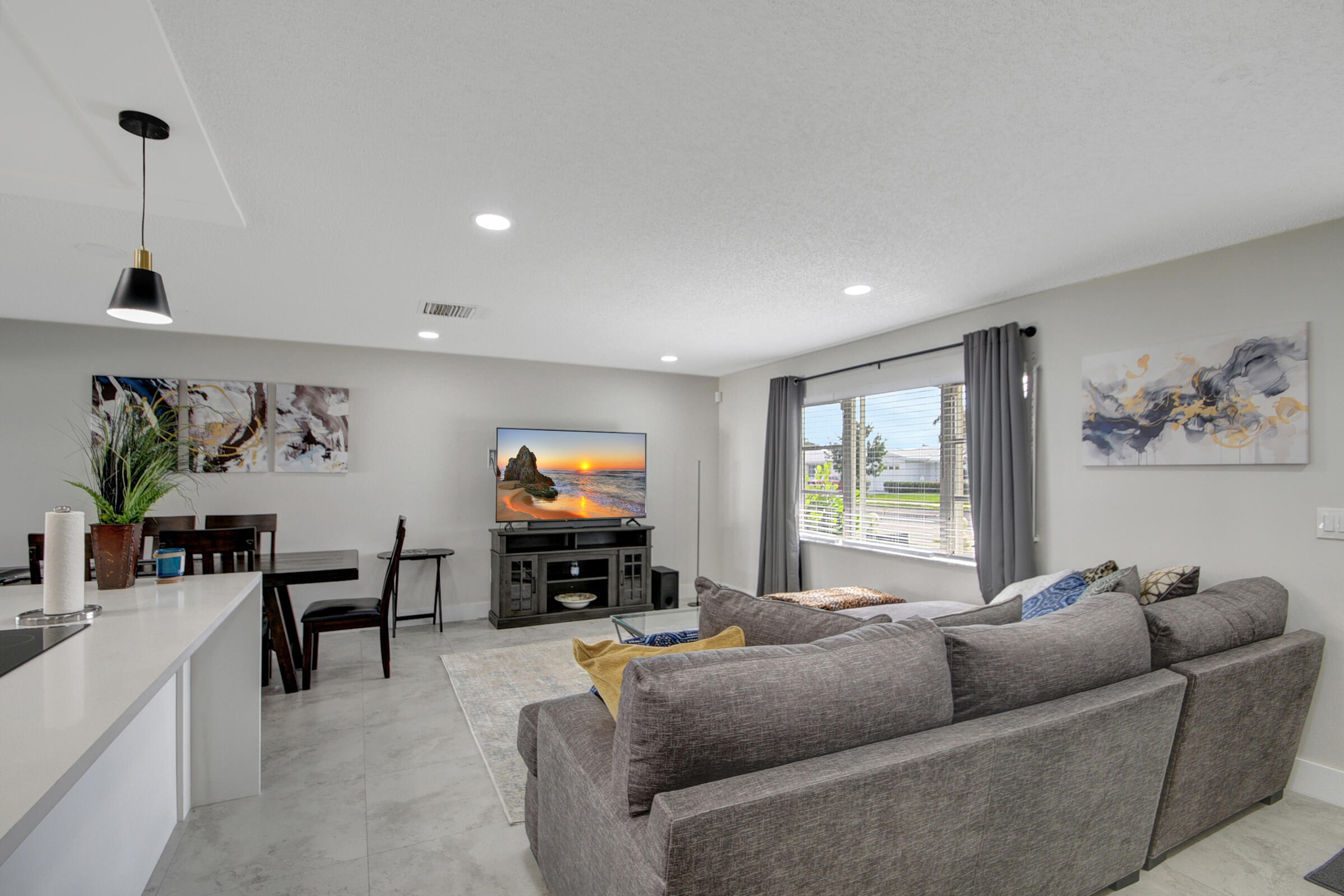 716 Southwest 18th Street Boynton Beach, FL 33426 - Photo 36 of 65 a living room with furniture and a flat screen tv