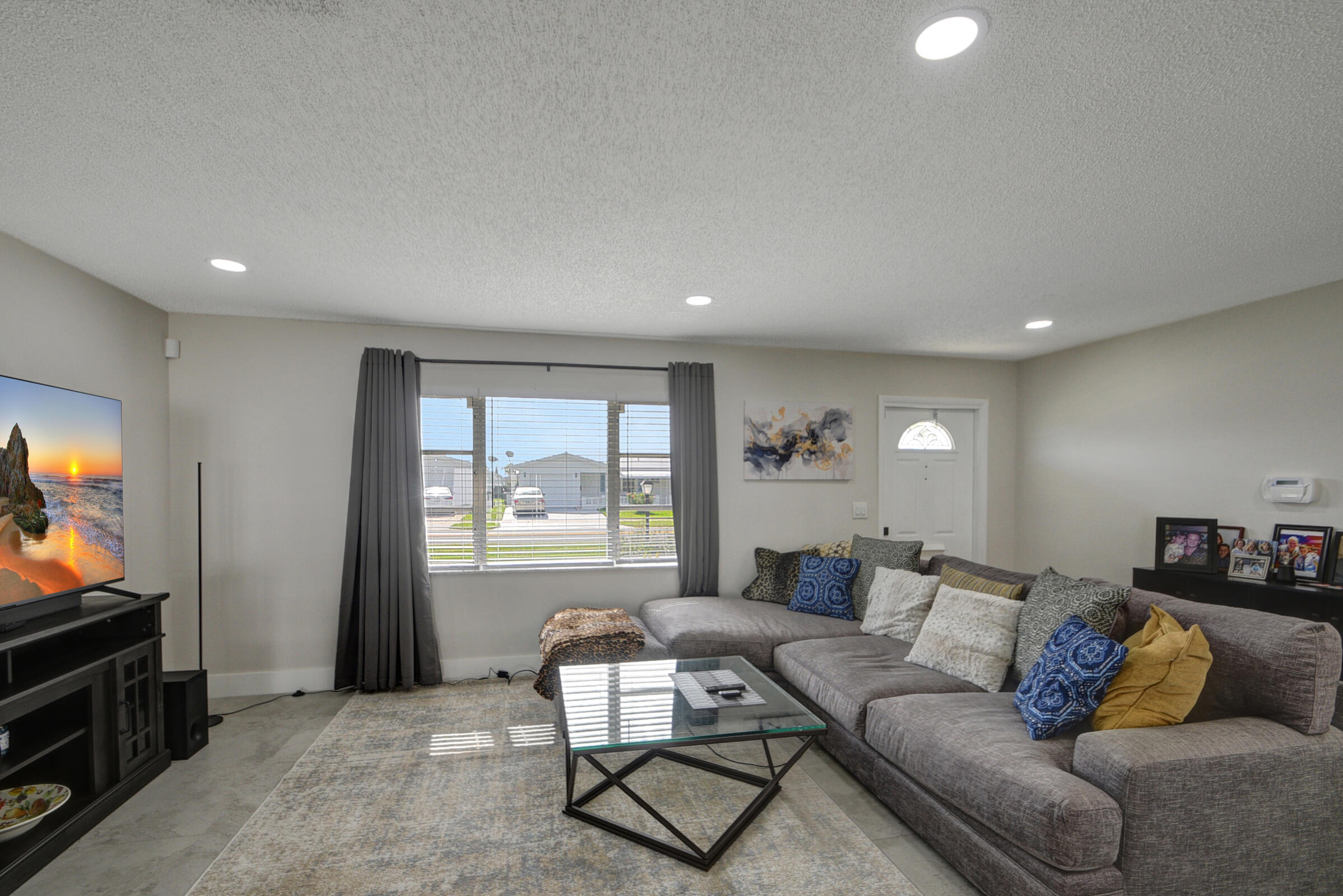716 Southwest 18th Street Boynton Beach, FL 33426 - Photo 37 of 65 a living room with furniture and a flat screen tv