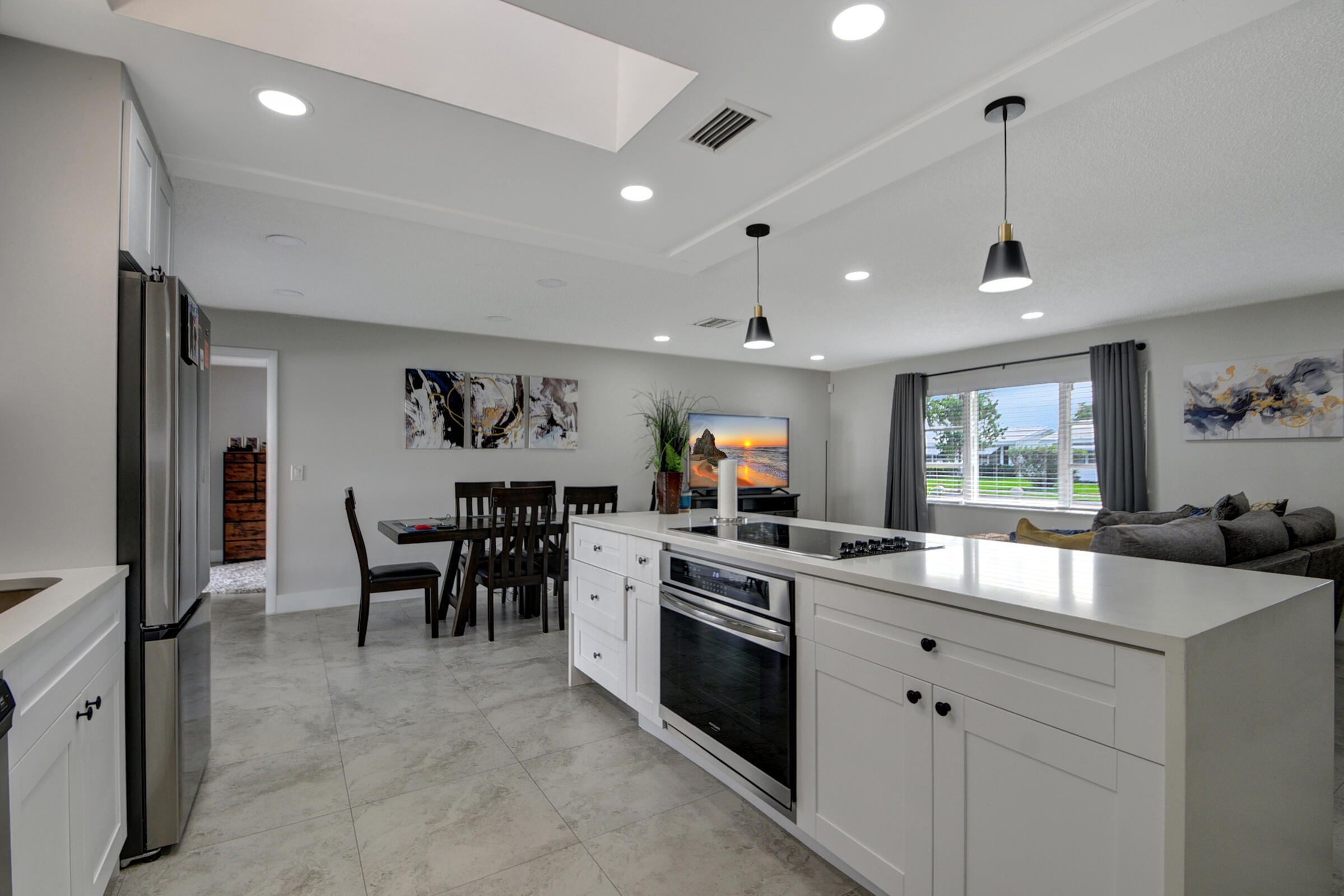 716 Southwest 18th Street Boynton Beach, FL 33426 - Photo 40 of 65 a kitchen that has a lot of cabinets a sink and appliances in it