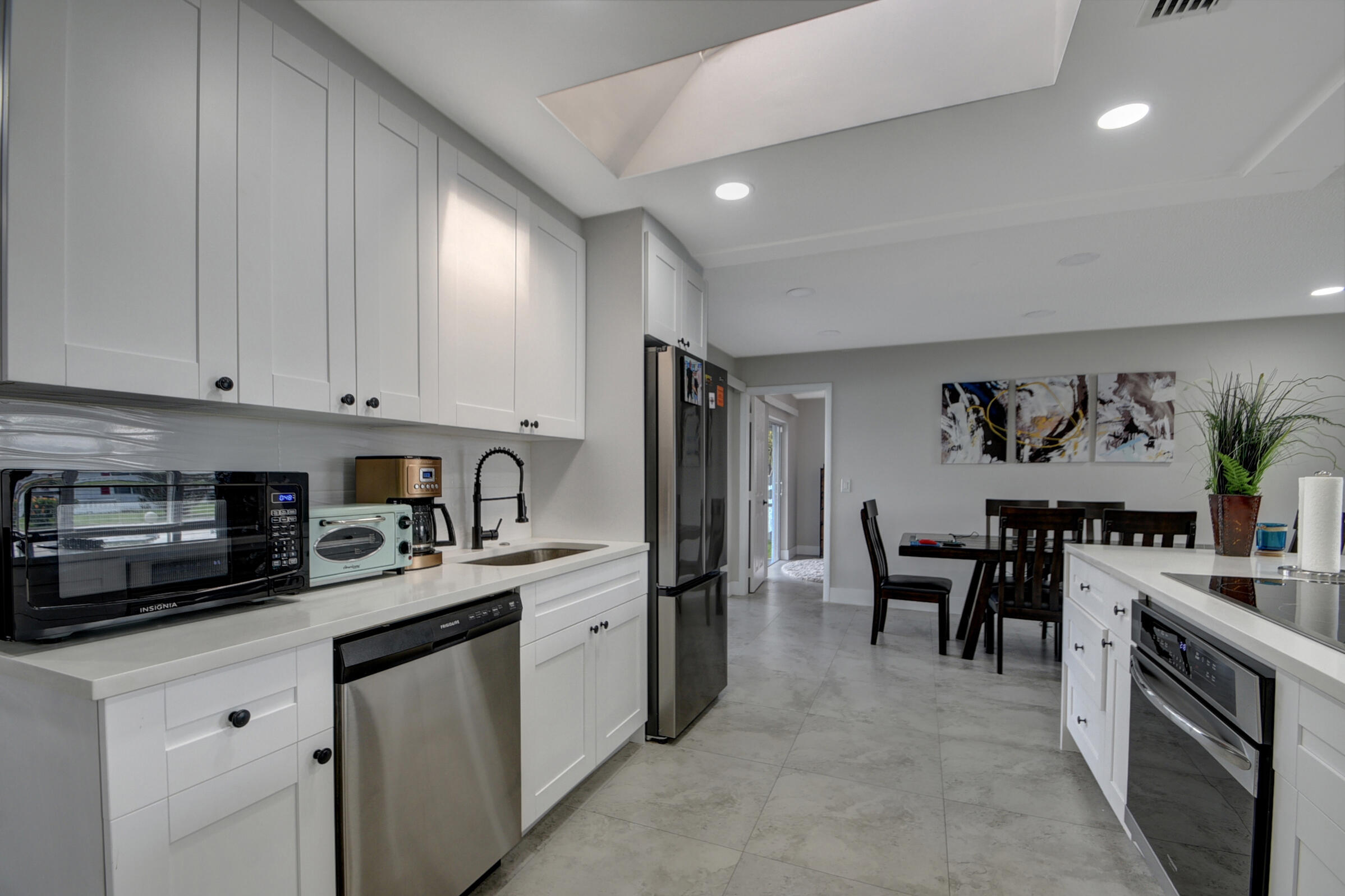 716 Southwest 18th Street Boynton Beach, FL 33426 - Photo 41 of 65 a kitchen with stainless steel appliances granite countertop a sink and cabinets