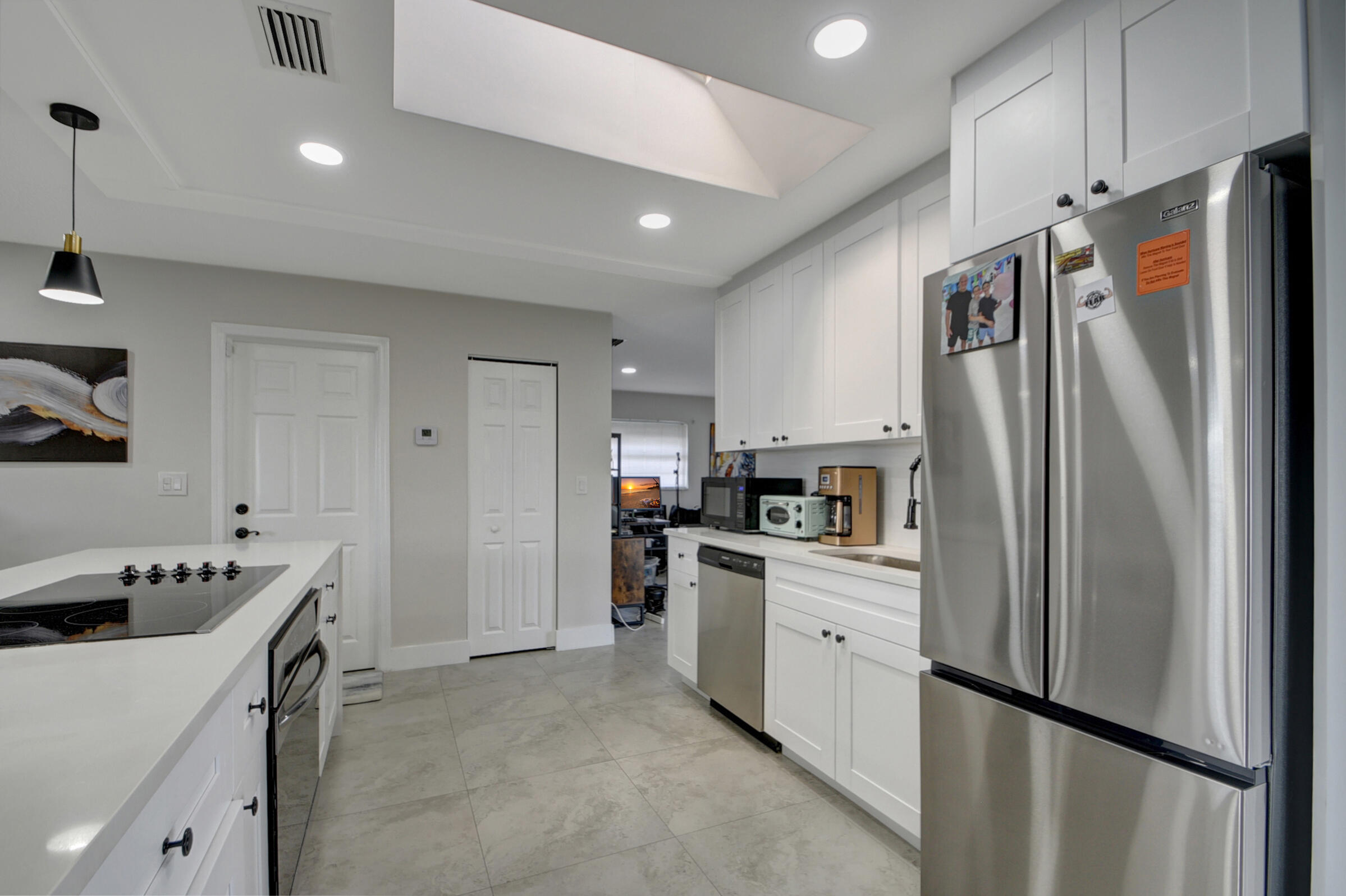 716 Southwest 18th Street Boynton Beach, FL 33426 - Photo 42 of 65 a kitchen with stainless steel appliances a refrigerator sink and cabinets
