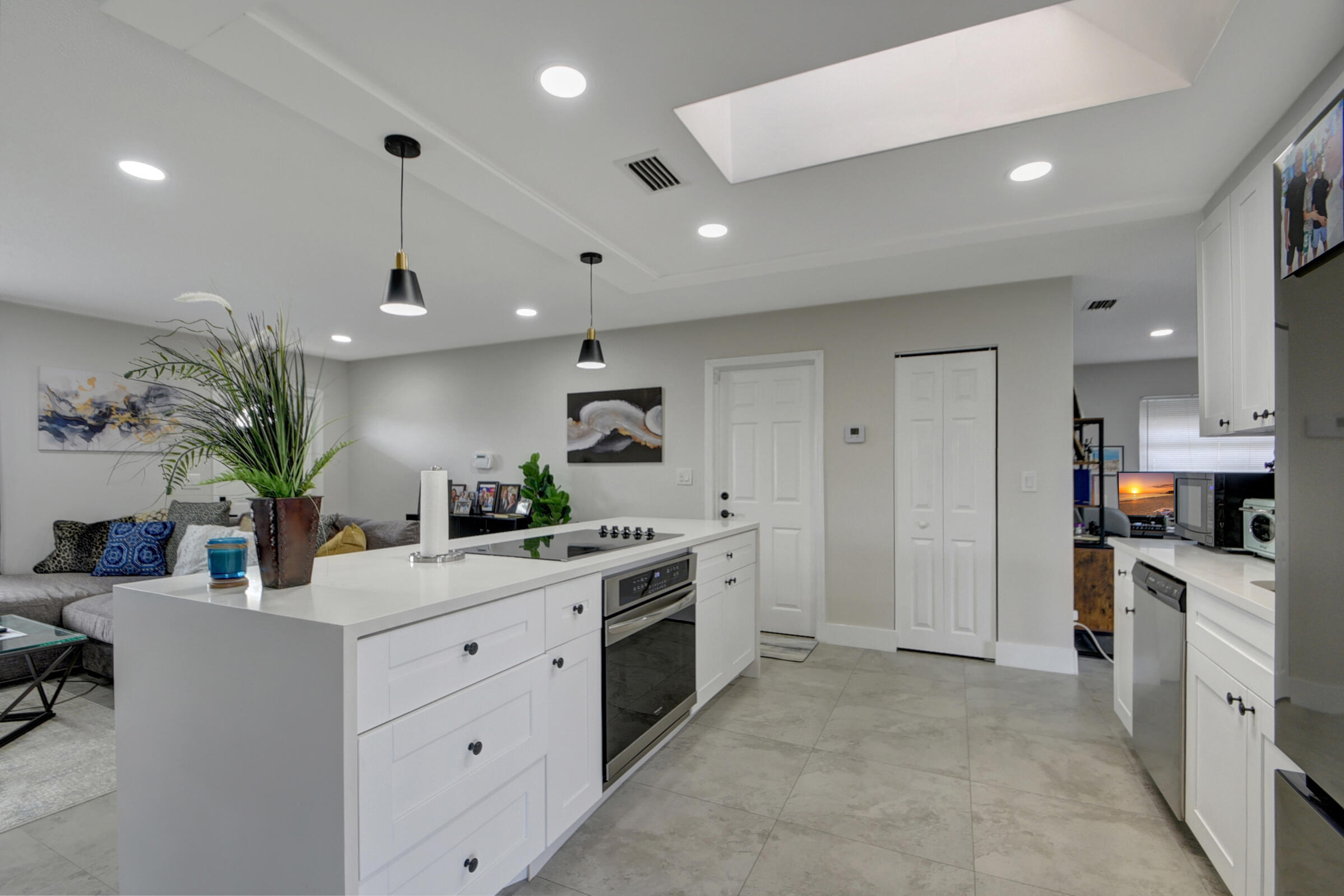 716 Southwest 18th Street Boynton Beach, FL 33426 - Photo 43 of 65 a kitchen with a white cabinets and stove top oven