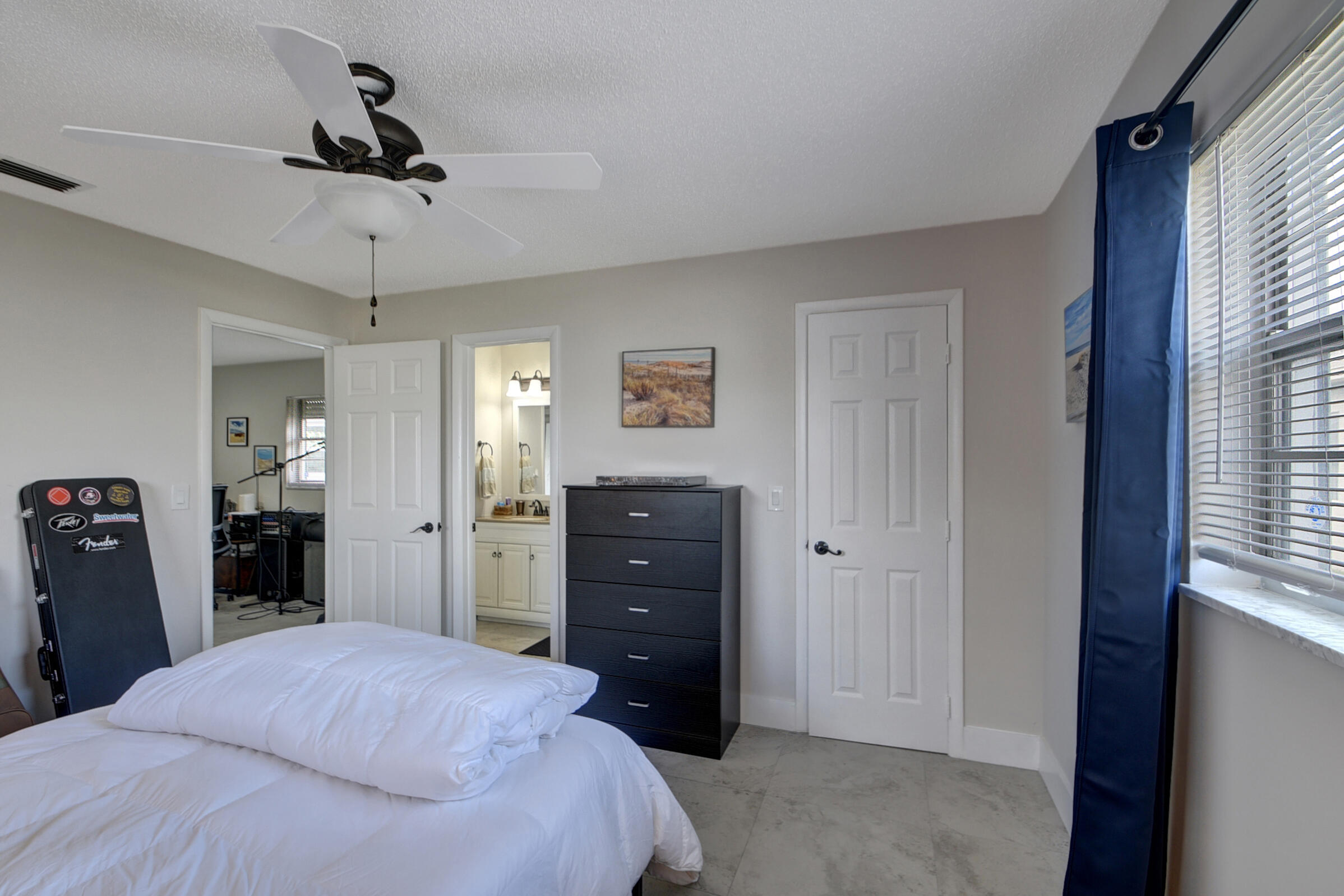 716 Southwest 18th Street Boynton Beach, FL 33426 - Photo 52 of 65 a bedroom with a bed and a dresser