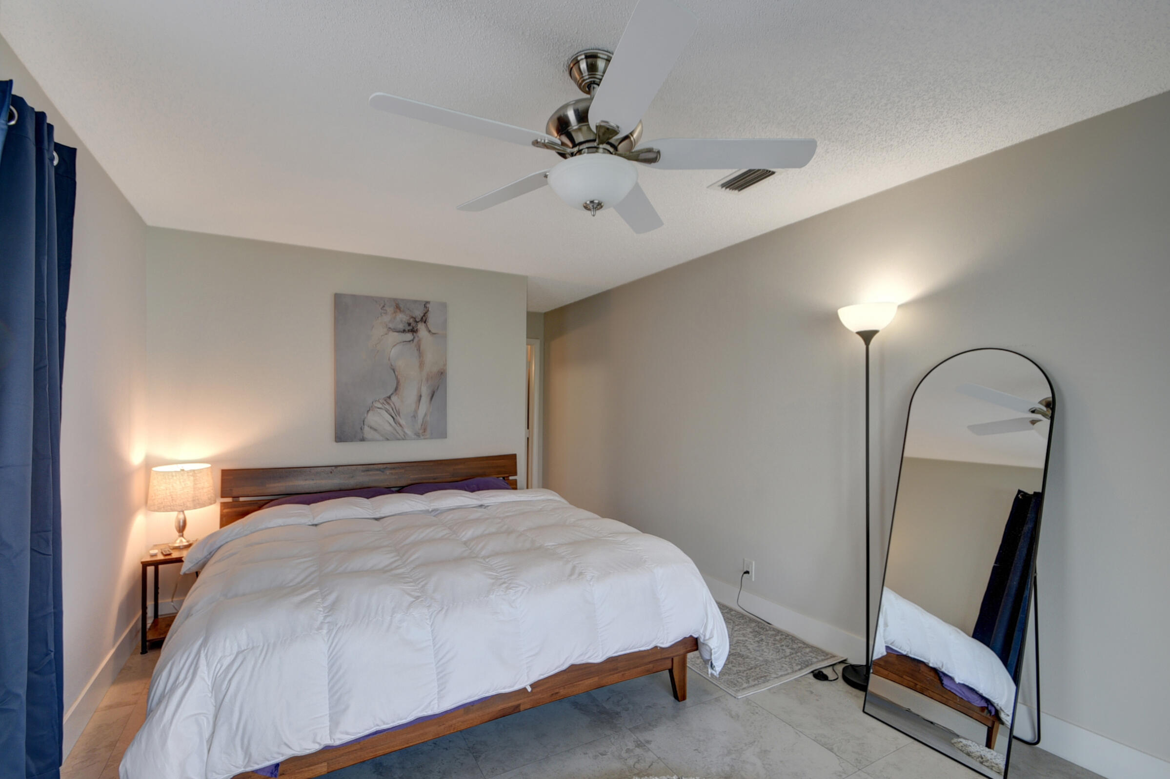 716 Southwest 18th Street Boynton Beach, FL 33426 - Photo 61 of 65 a bedroom with a bed and a mirror