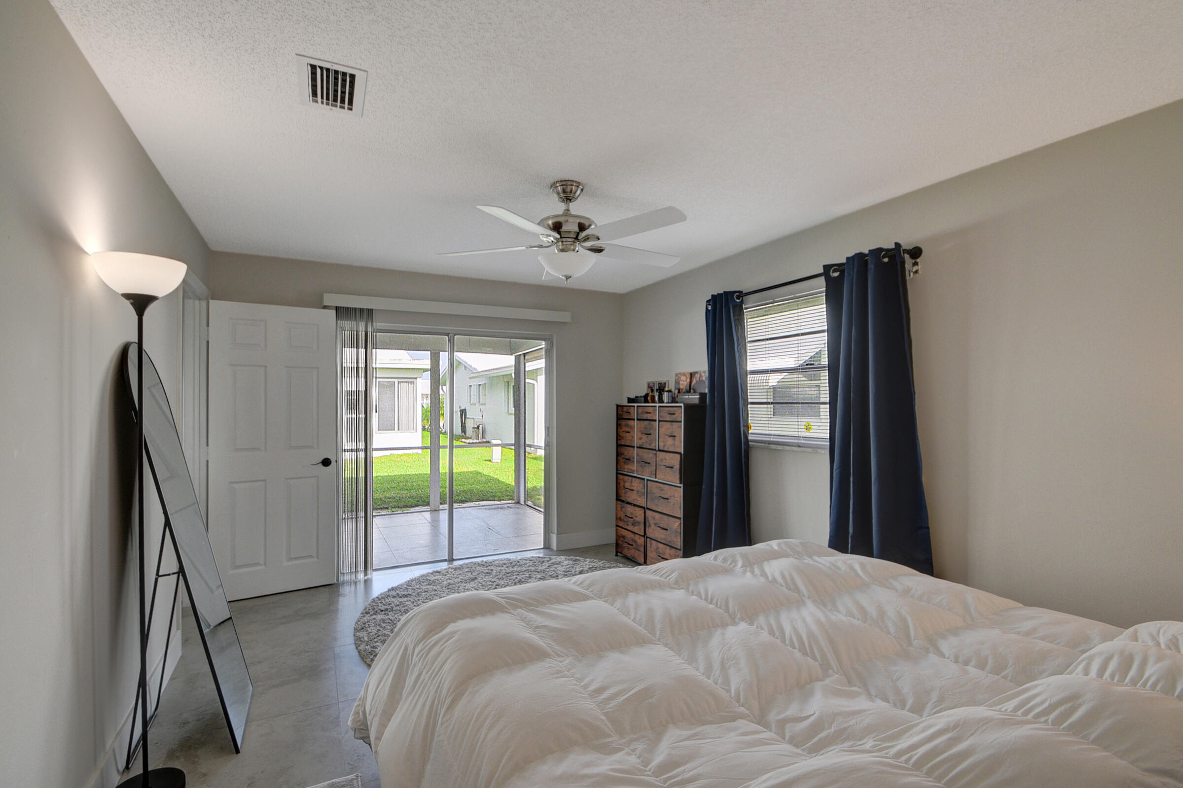 716 Southwest 18th Street Boynton Beach, FL 33426 - Photo 62 of 65 a bedroom with a bed and a large window