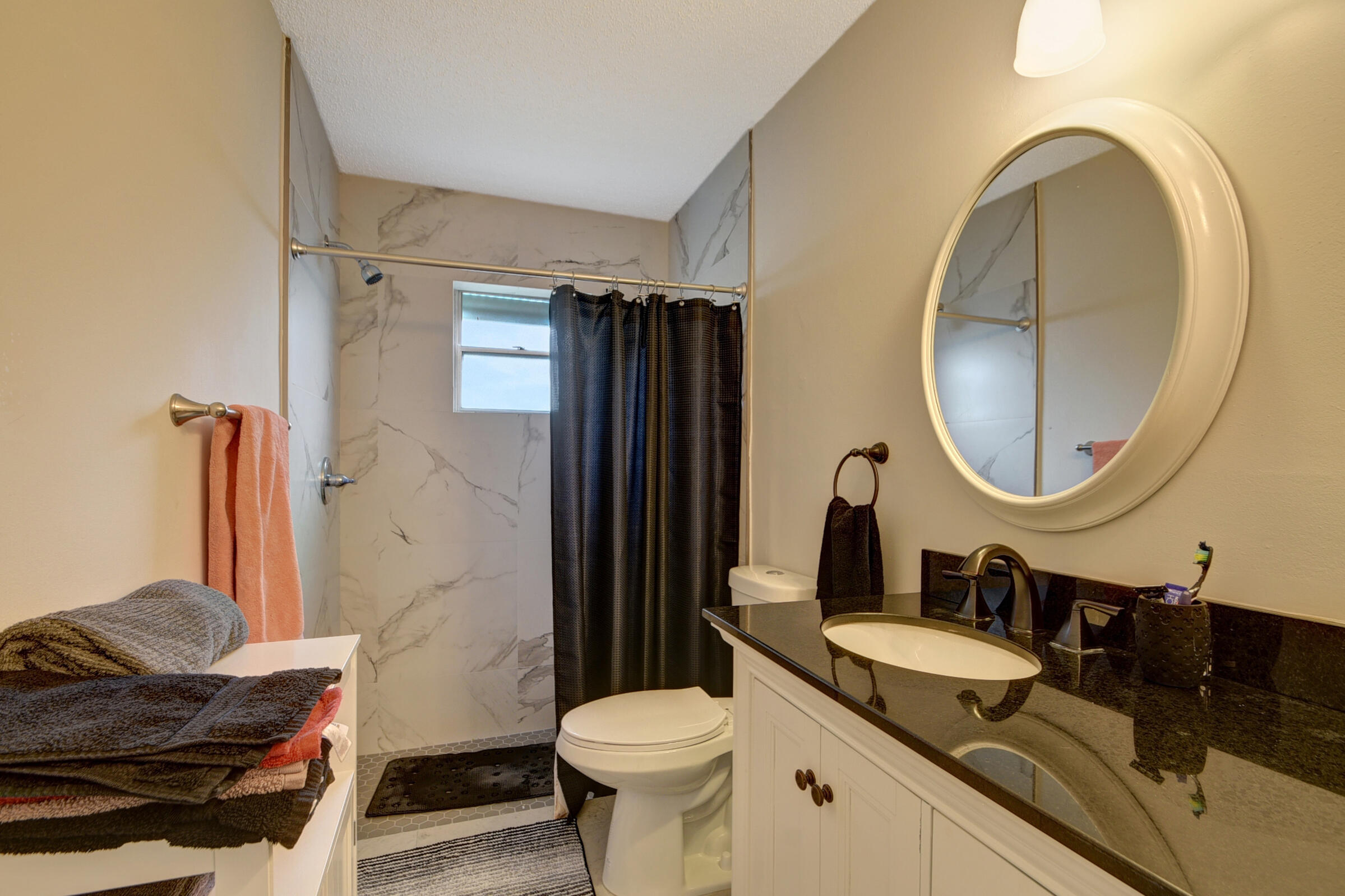 716 Southwest 18th Street Boynton Beach, FL 33426 - Photo 64 of 65 a bathroom with a granite countertop toilet sink and mirror