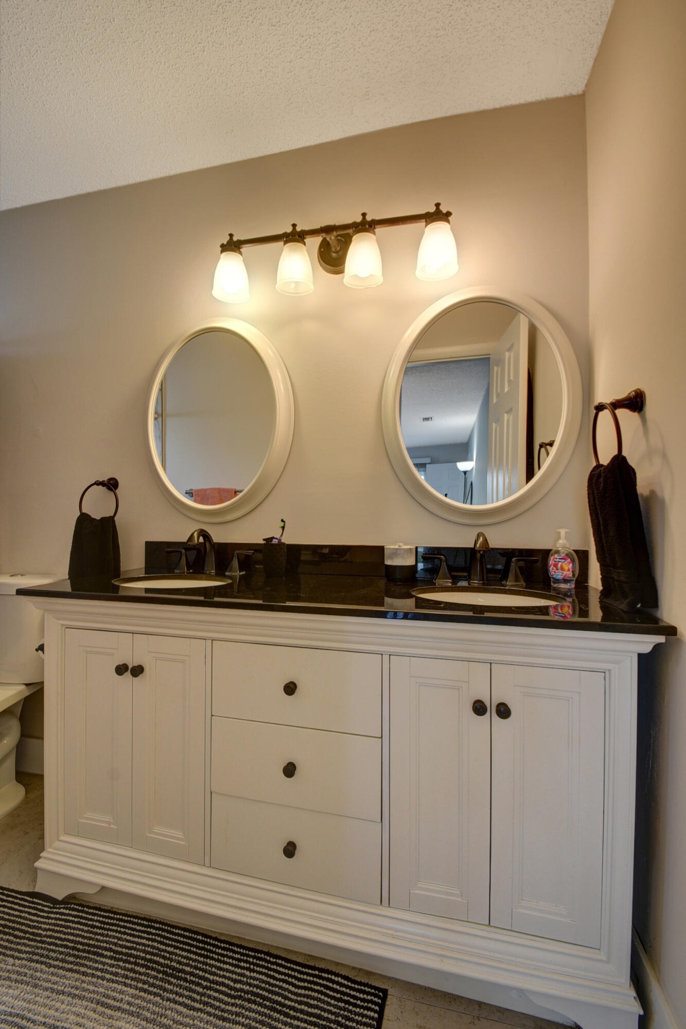 716 Southwest 18th Street Boynton Beach, FL 33426 - Photo 65 of 65 a bathroom with a double vanity sink and a mirror