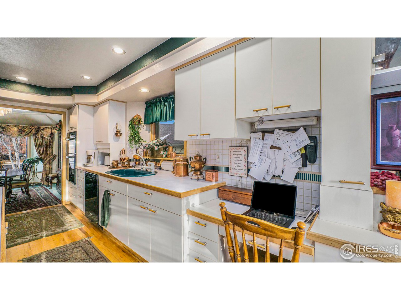 4328 West 14th Street Road Greeley, CO 80634 - Photo 11 of 30 a kitchen with stainless steel appliances kitchen island granite countertop a sink and cabinets
