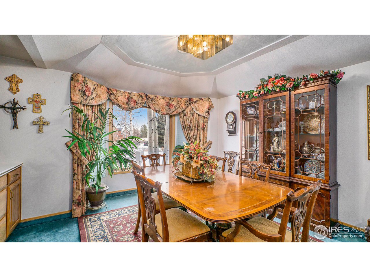 4328 West 14th Street Road Greeley, CO 80634 - Photo 13 of 30 a view of a dining room with furniture and chandelier