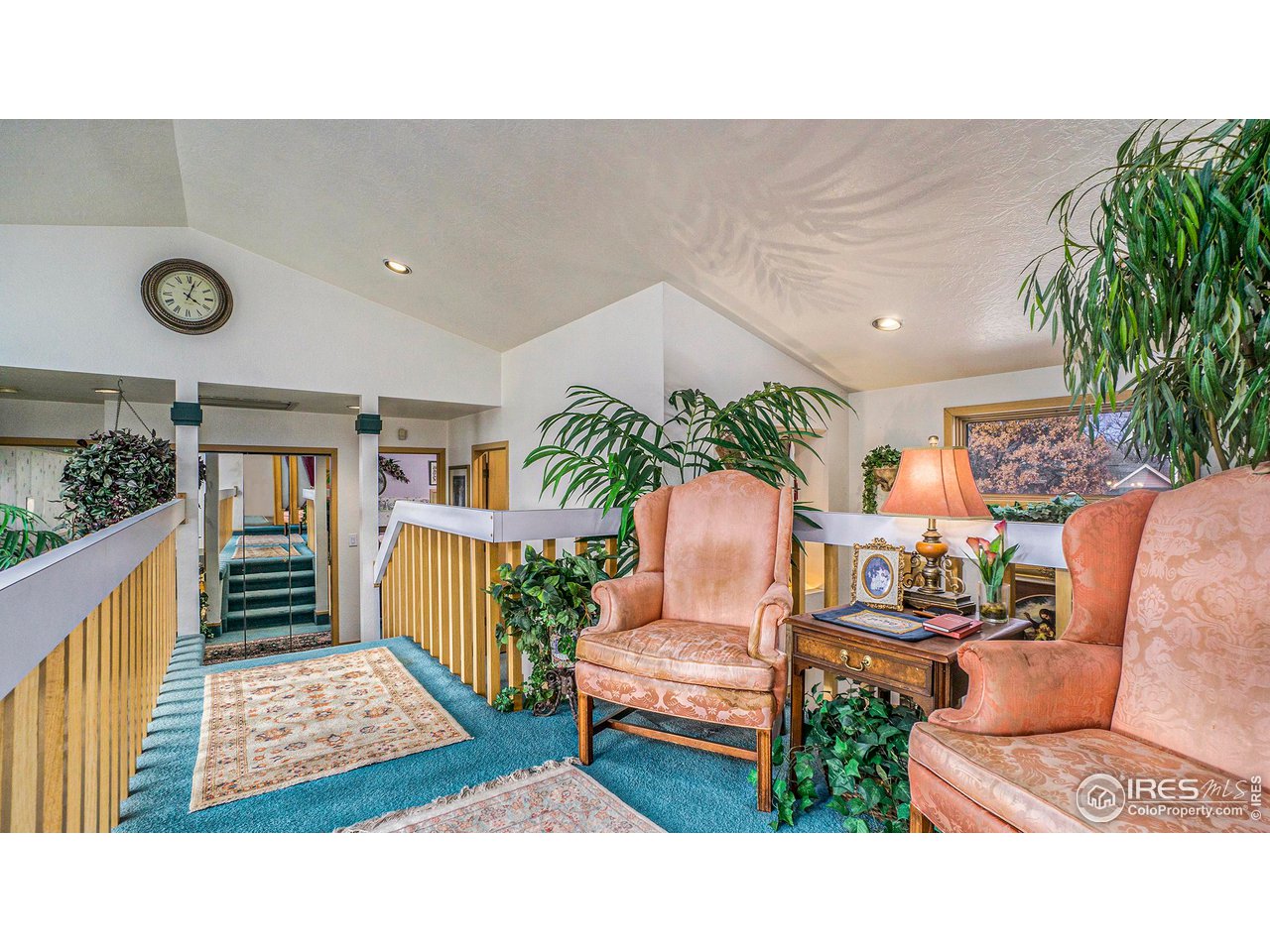 4328 West 14th Street Road Greeley, CO 80634 - Photo 19 of 30 a living room with furniture and a book shelf