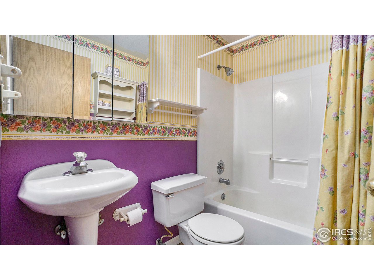 4328 West 14th Street Road Greeley, CO 80634 - Photo 24 of 30 a bathroom with a sink toilet mirror and shower