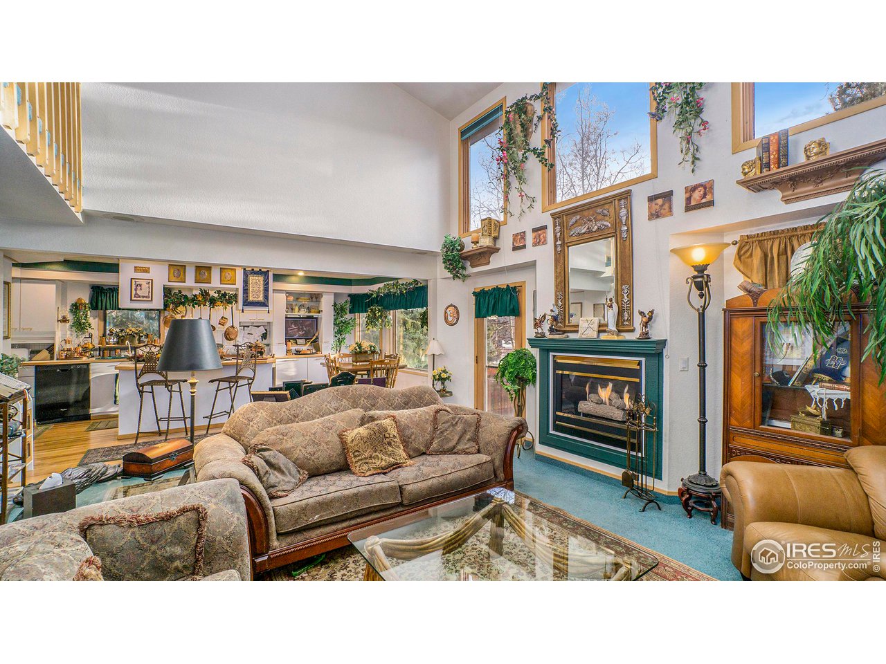 4328 West 14th Street Road Greeley, CO 80634 - Photo 6 of 30 a living room with furniture a fireplace and a table