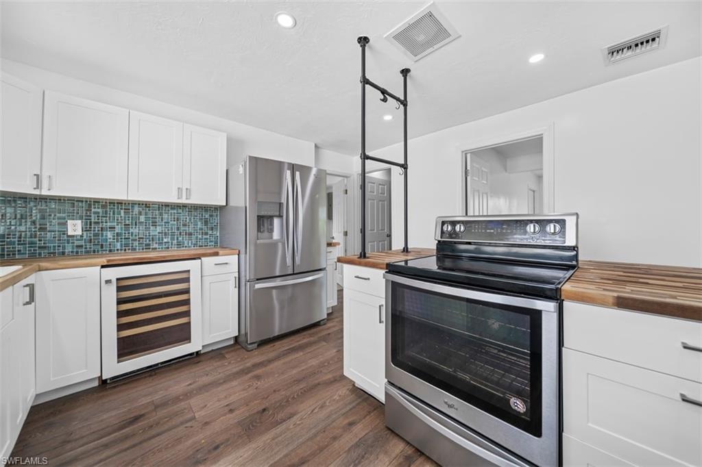 5460 Bayshore Road North Fort Myers, FL 33917 - Photo 7 of 14 a kitchen with a stove and a microwave oven