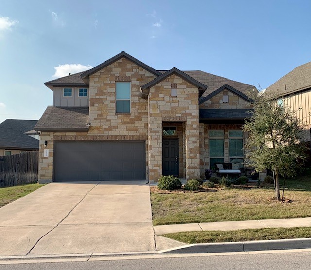 13132 Olivers Way Manchaca, TX 78652 - Photo 1 of 1 a front view of a house with garden
