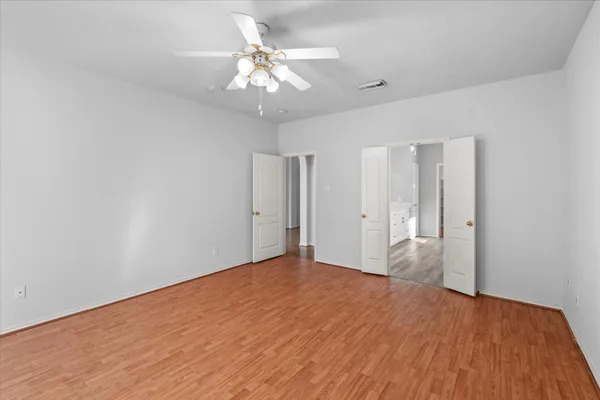 a view of empty room with wooden floor
