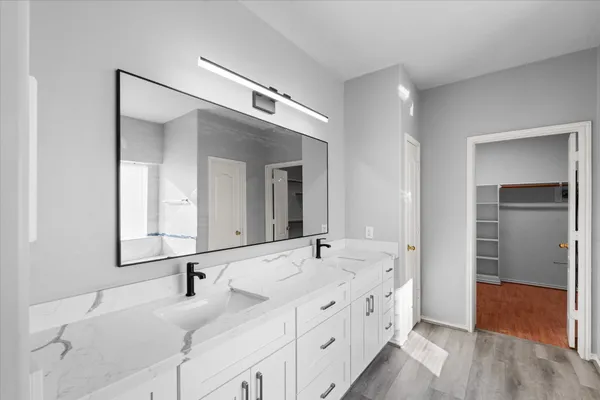 a bathroom with a double vanity sink and mirror