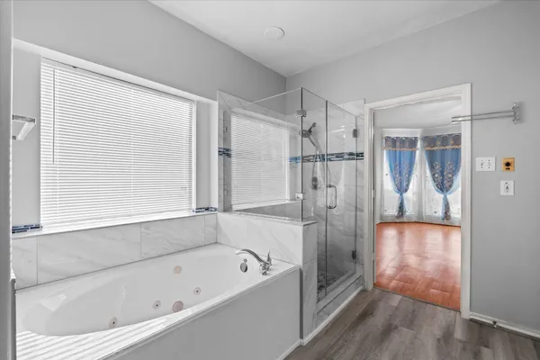 a bathroom with a bathtub and a shower