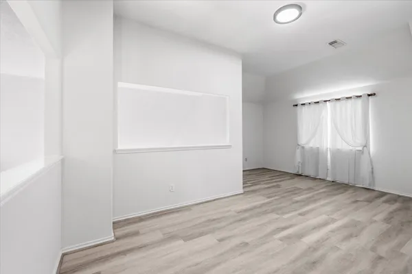 an empty room with wooden floor