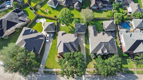 an aerial view of houses with yard
