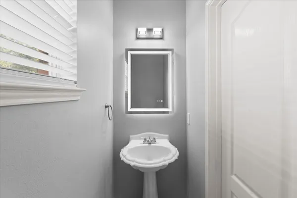 a bathroom with a sink and a mirror