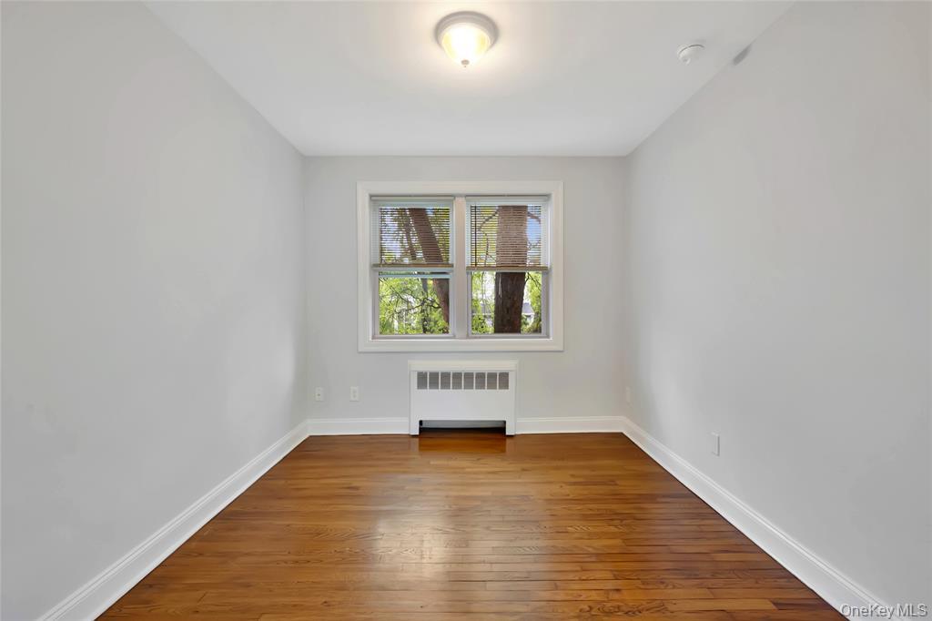 504 Pelham Road New Rochelle, NY 10805 - Photo 13 of 26 wooden floor in an empty room with a window
