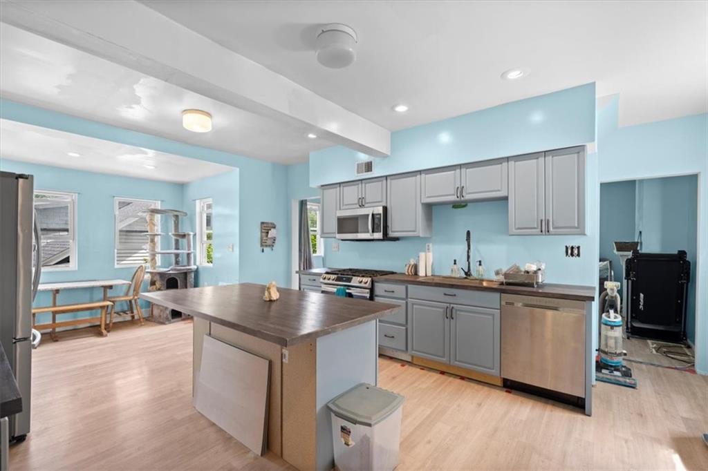 133 Owen Street McKees Rocks, PA 15136 - Photo 4 of 25 a large kitchen with stainless steel appliances granite countertop a lot of counter space and wooden floor