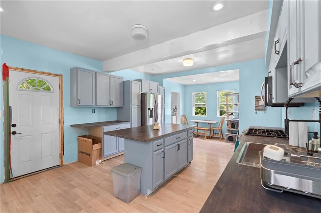 133 Owen Street McKees Rocks, PA 15136 - Photo 5 of 25 a large kitchen with stainless steel appliances granite countertop a lot of counter space and a window