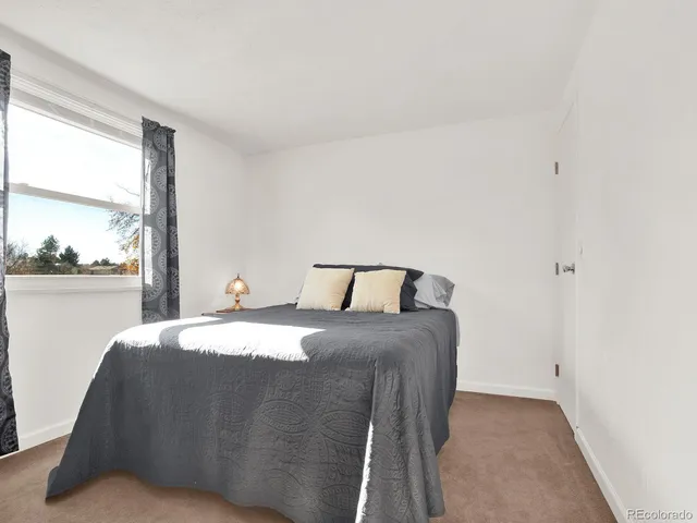a view of a patio with table and chairs and wooden fence