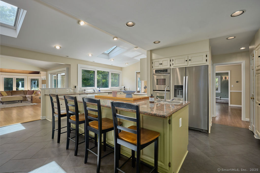 81 Norfield Road Weston, CT 06883 - Photo 12 of 40 a room with kitchen island granite countertop furniture and a dining table