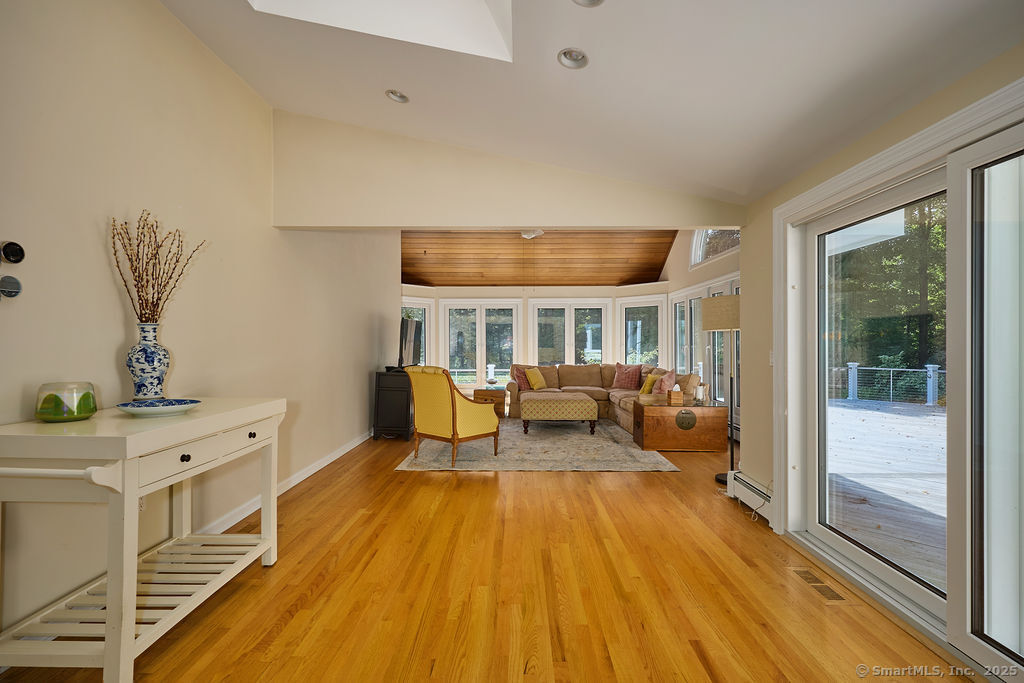 81 Norfield Road Weston, CT 06883 - Photo 15 of 40 a spacious bedroom with a bed and wooden floor