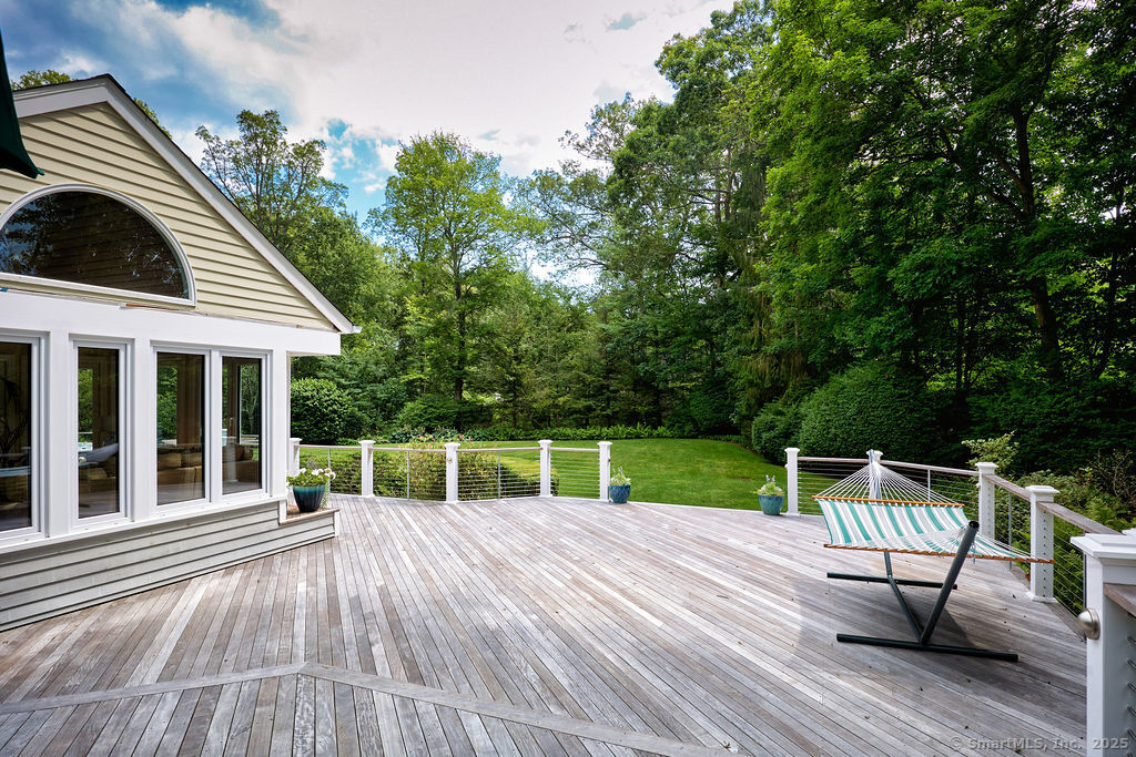 81 Norfield Road Weston, CT 06883 - Photo 17 of 40 a view of house with deck outdoor seating and green space