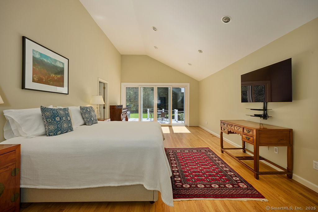 81 Norfield Road Weston, CT 06883 - Photo 20 of 40 a living room with a couch and a flat screen tv