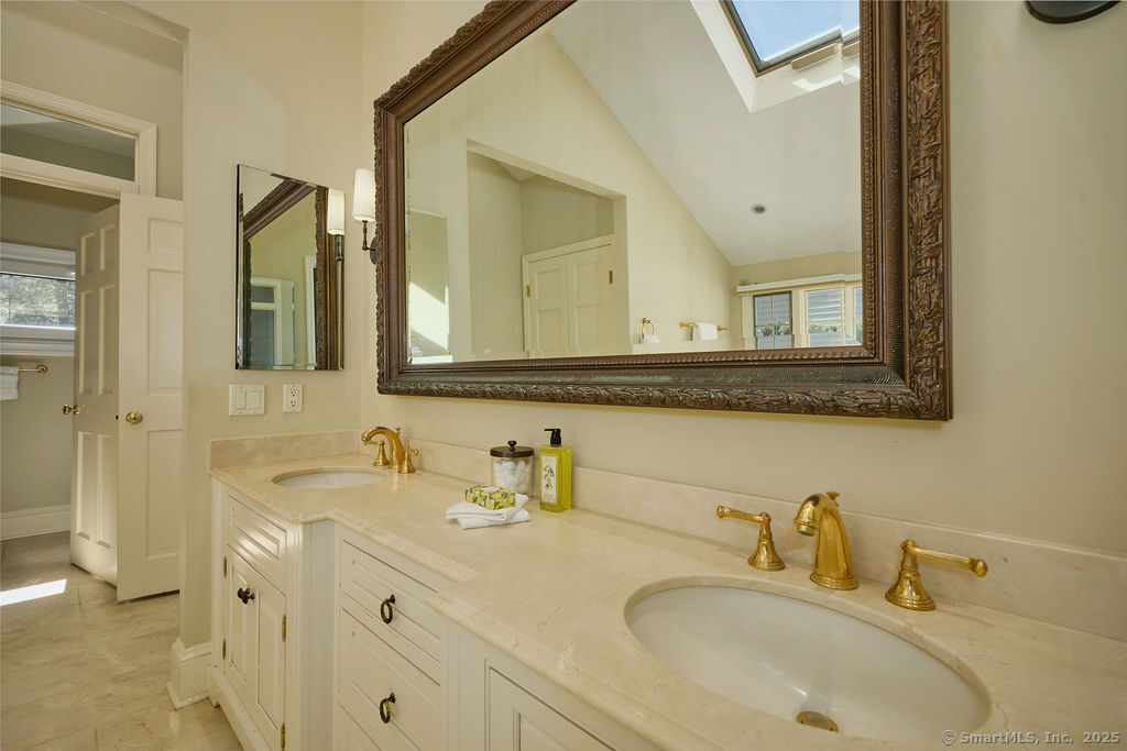 81 Norfield Road Weston, CT 06883 - Photo 21 of 40 a bathroom with a sink and a mirror