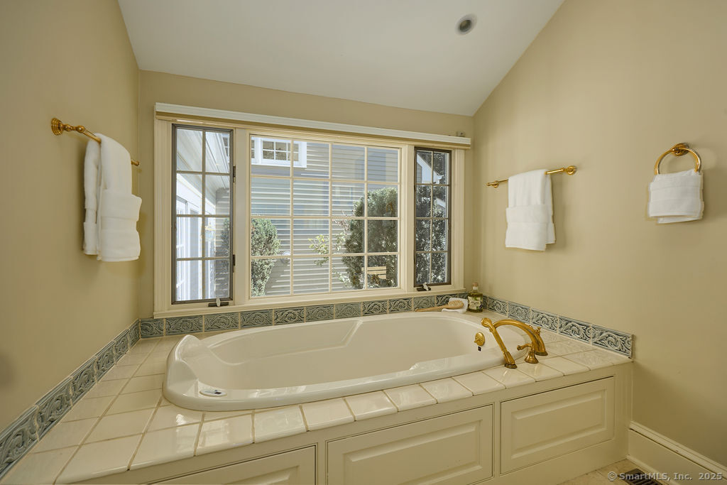 81 Norfield Road Weston, CT 06883 - Photo 22 of 40 a bath tub sitting next to a window