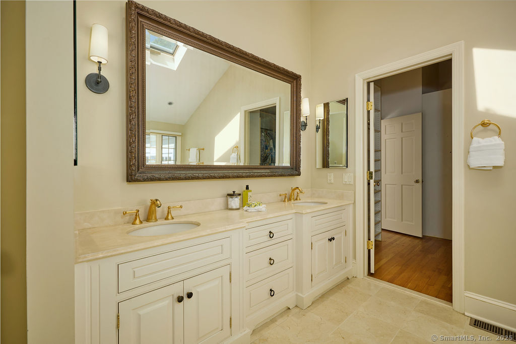 81 Norfield Road Weston, CT 06883 - Photo 23 of 40 a bathroom with double sink and a mirror