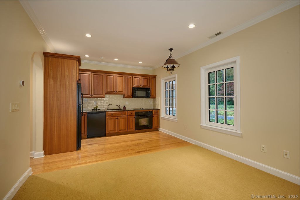 81 Norfield Road Weston, CT 06883 - Photo 26 of 40 a view of a kitchen with a sink and dishwasher a refrigerator with wooden floor
