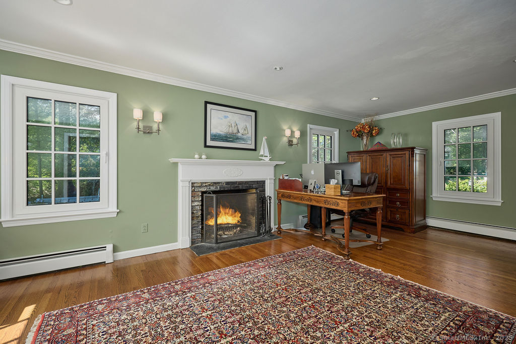 81 Norfield Road Weston, CT 06883 - Photo 27 of 40 a living room with furniture and a fireplace
