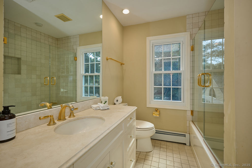 81 Norfield Road Weston, CT 06883 - Photo 35 of 40 a bathroom with a granite countertop sink a toilet and shower