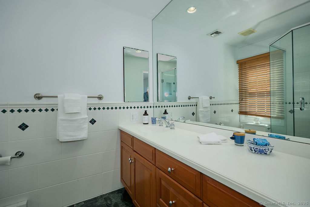 81 Norfield Road Weston, CT 06883 - Photo 37 of 40 a bathroom with a sink and a mirror