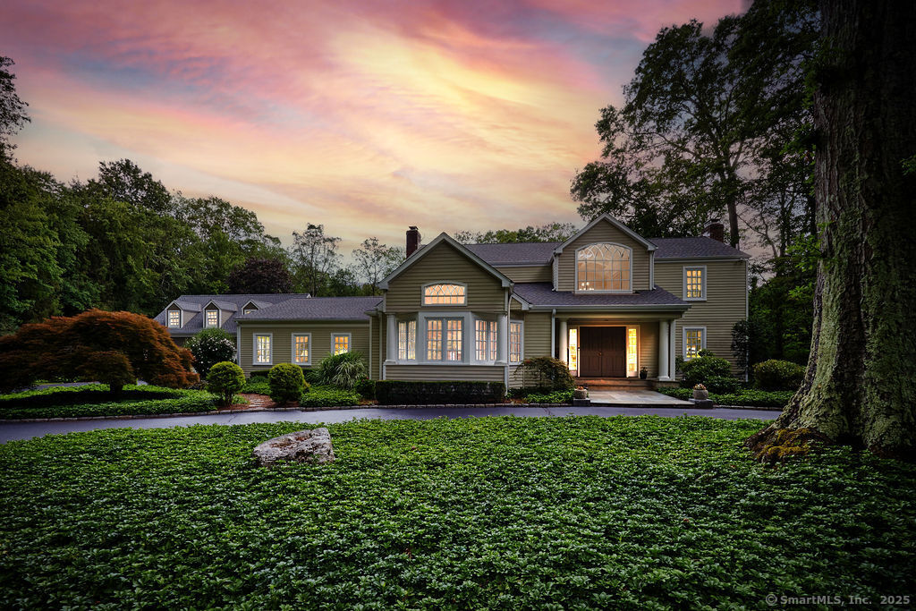 81 Norfield Road Weston, CT 06883 - Photo 40 of 40 a front view of a house with a yard and potted plants