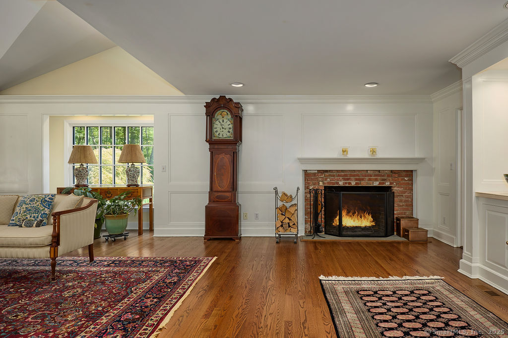 81 Norfield Road Weston, CT 06883 - Photo 7 of 40 a living room with furniture a rug and a fireplace