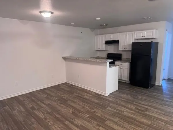 a kitchen with stainless steel appliances a sink a stove a refrigerator and cabinets