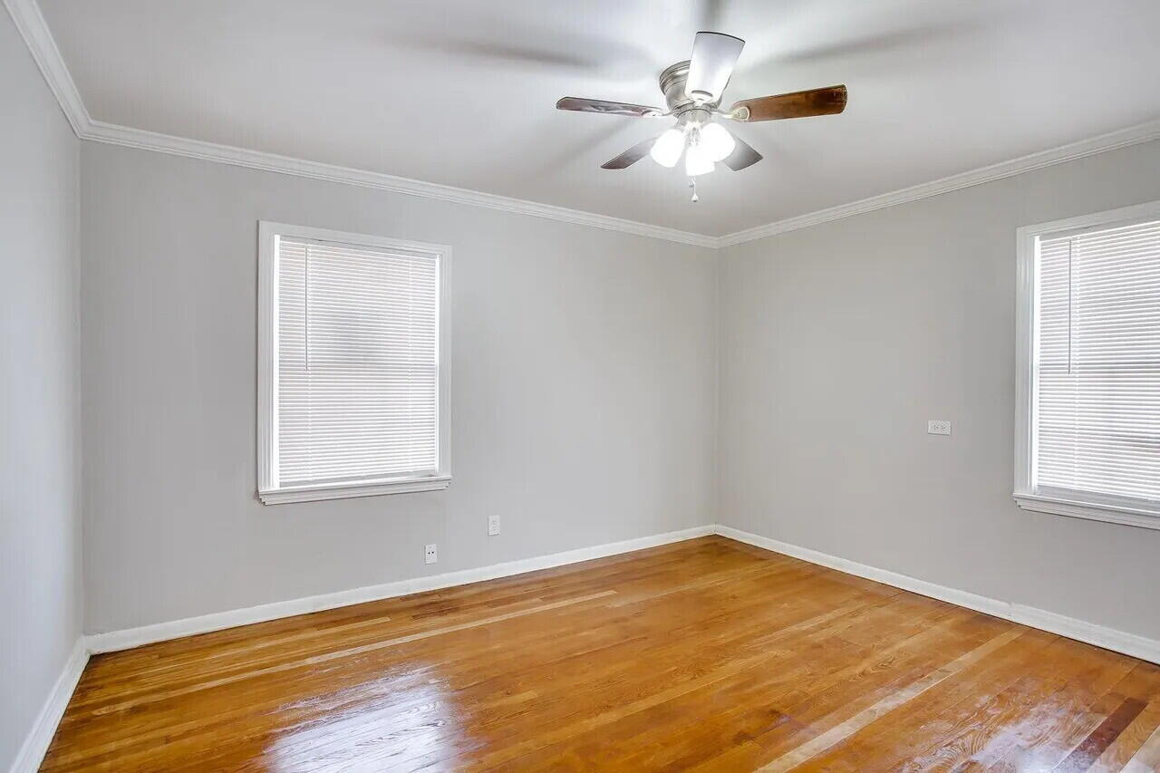 2706 36th Street Lubbock, TX 79413 - Photo 12 of 15 an empty room with windows and ceiling fan