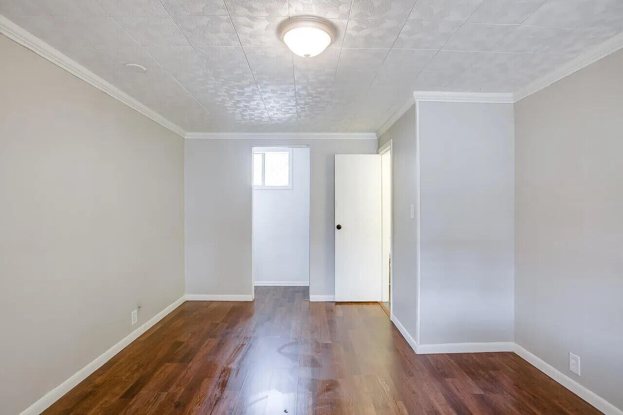 2706 36th Street Lubbock, TX 79413 - Photo 15 of 15 an empty room with wooden floor and windows